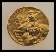 An 18ct gold French medallion of St Georges marked Becker having St George slaying the dragon and