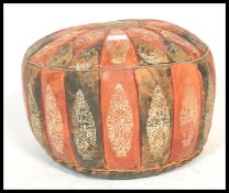 A vintage mid 20th Century Moroccan patchwork leather pouffe, the pouffe decorated with tooled