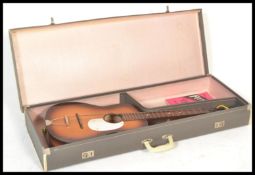 A vintage 1960's six string acoustic guitar by Kansas, the sunburst body with applied white fret