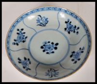 A 19th Century Chinese blue and white plate, Kangxi, painted with foliate panels with geometric
