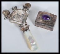A silver hallmarked lil bo peep babies rattle having mother of pearl teething handle along with a