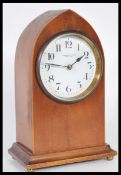 An Edwardian mahogany inlaid spire shaped mantel clock with enamel dial being marked for Pleasance &