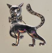 A sterling silver figural brooch in the form of a cat decorated with marcasites. Weighs 6 grams.