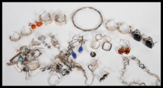 A large selection of silver earrings to include stud earrings, hooped earrings and drop earrings,
