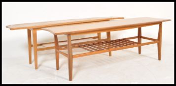 Two vintage retro 20th Century coffee tables consisting of a teak example with railed magazine