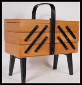 A retro 20th Century metamorphic cantilever sectional work-box / sewing box and contents, carry