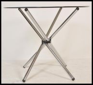 A contemporary chrome and glass coffee table / occasional table of atomic / sputnik form being in
