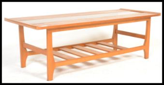 A retro 20th Century teak wood coffee table of rectangular form, having an inset central class panel