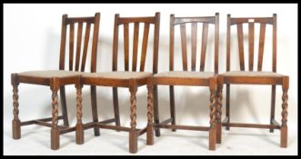 A set of four early 20th Century circa 1930's rail back dining chairs raised on barley twist