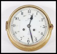 A vintage 20th century Royal Mariner 20th century brass cased bulkhead clock with white dial and 8