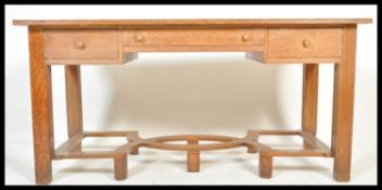 A 19th century believed Heals & Co Cotswold school faux partners desk. Raised on geometric crinoline