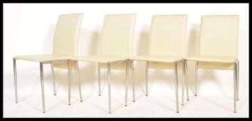 A set of 4 20th century modernist chrome and white faux leather dining chairs. Tubular chrome frames