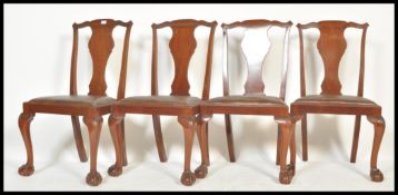 A set of four Edwardian mahogany dining chairs, the chairs being raised on Queen Anne claw and