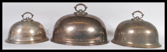 A collection of three 20th Century silver plated graduating meat platters having gadrooned finial