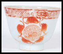 A 19th Century Chinese porcelain tea bowl cup having hand painter ochre decoration depicting