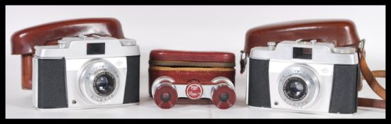 Two vintage retro Agfa Silette Vario film cameras in fitted brown leather cases, along with a pair