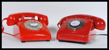 A pair of vintage retro 20th Century telephones having ring dial fronts with phones to top. Finished