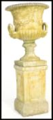 A large  20th Century well weathered stone garden planter campana  urn raised on square column
