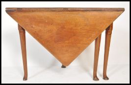 An early 18th Century Queen Anne or early George I walnut folding game or tea table of unusual
