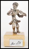 An Israeli silver stamped 925 silver figurine by Ben Zion depicting a street violinist on a wooden