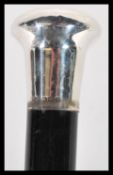 An early 20th Century walking stick cane having an ebonised wooden shaft along with a silver