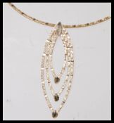 A stamped 375 9ct gold necklace having a snake chain with a graduating ellipse shaped pendant. Total