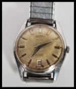 A vintage 1960s Rotary Calendar watch having a champagne dial with baton numerals and faceted hands.