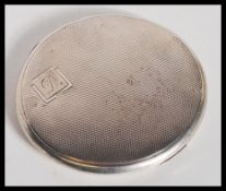 A hallmarked 20th Century silver compact of circular form by William Suckling Ltd having engine