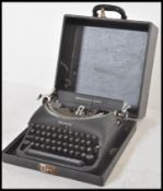 A vintage 20th Century retro Remington Rand typewriter having a matte black finish with white
