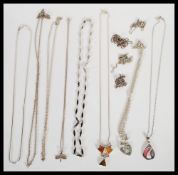 A selection of silver necklaces to include necklace chains, a mother of pearl pendant, a heart