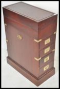 A 20th Century hard wood campaign style chest having a run of three drawers and fold over top,