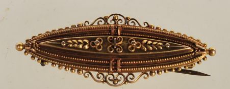A hallmarked Edwardian 15ct gold bar brooch, the central raised panel raised in relief with