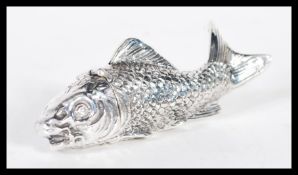 A sterling silver vesta case in the form of a fish having hinged lid to head. Weighs 50 grams.