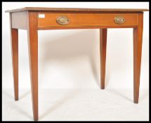 An early 19th Century Georgian mahogany writing table desk raised on square tapered legs with single