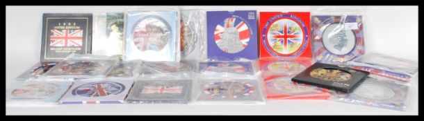 A collection of commemorative British uncirculated coin sets, all coins remaining in original