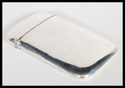 An early 20th Century George V hallmarked silver card case by William H Sparrow of curved form