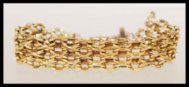 A stamped 375 9ct gold mesh link bracelet with spring ring clasp. Total weight 13.9g. 19cm long.