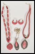 A collection of pink Rhodonite and silver jewellery to include a pair of hooped earrings, a silver