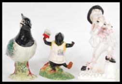 A group of ceramic figurines to include Beswick 2416 Lapwing bird figurine, Royal Doulton Wind in