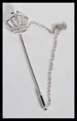 A sterling silver hat pin in the form of a crown decorated with CZ stones. Weighs 4 grams.