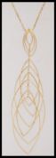 A 9ct gold ladies dress necklace with a curb chain and cascading ellipse drop detailing. Stamped