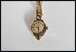 A hallmarked 9ct gold Rotary watch having a champagne dial with gilt numeral chapter ring and