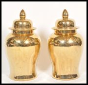 A large pair of decorative gold lustre ginger jars, each of contemporary design being of baluster