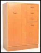 E Gomme for G Plan - light oak tallboy, with full length hanging cupboard to the left alongside