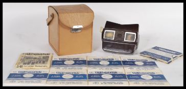 A vintage 20th Century bakelite cased view master in a leatherette carrying case complete with a