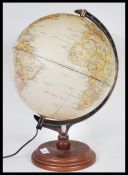 A 20th century table top  desk top illuminated globe. Raised on faux rosewood circular base with
