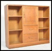 An early 20th century Cotswold school believed Heals of London library bookcase cabinet having