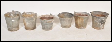 A collection of six vintage 20th Century galvanised metal / tin  water buckets, each fitted with