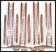 An unusual Indian hardwood handpainted bed having red and green ground with geometric decoration,