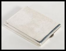 An early 20th Century George V hallmarked silver match book cover of plain rectangular form by